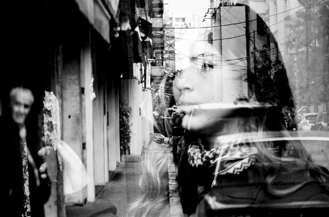a double exposure image of a young woman and an old lady against an old street