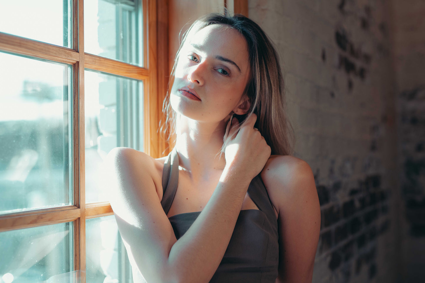 Woman standing by a window with natural light