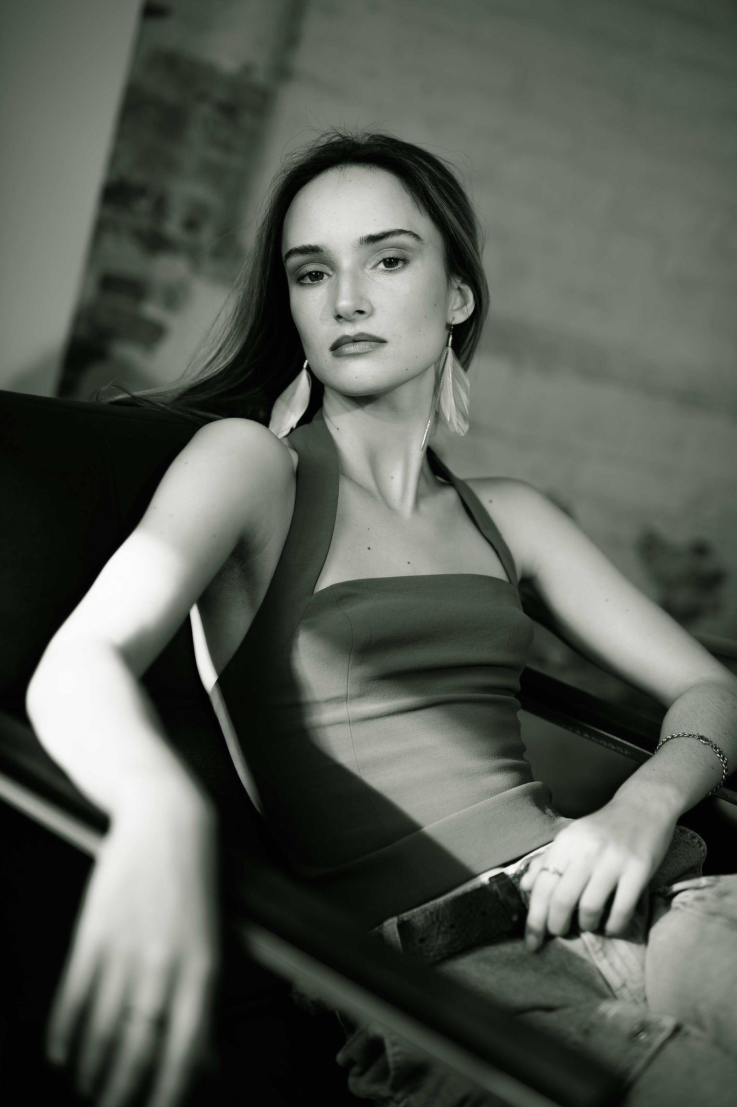 Woman sitting on a couch in a black and white photo