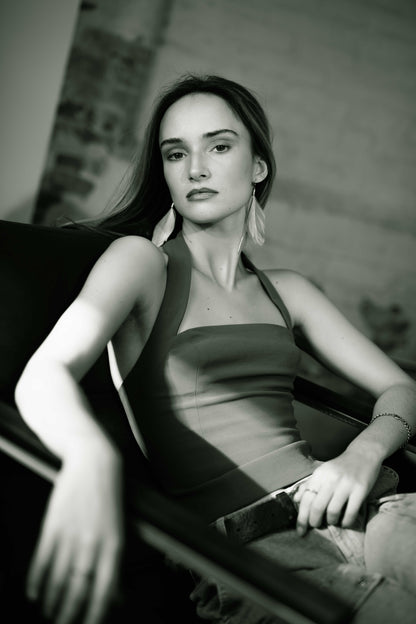 Woman sitting on a couch in a black and white photo